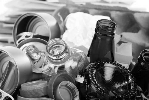 Company van and skip on site with workers preparing for safe operations